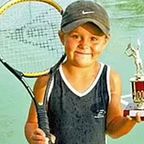 A young Ash Barty holds up a trophy