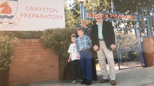 The Kearsleys outside the children's school. 