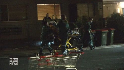 A shooting victim in Adelaide is wheeled towards an ambulance.