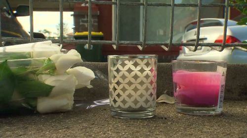 Flowers and candles outside the Chan home in Endfield, in Sydney's west. (9NEWS)