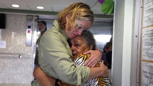 San Juan's Mayor Carmen Yulin Cruz hugs a woman during her visit to an elderly home in San Juan, Puerto Rico. (AAP)