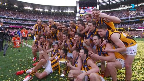 The Hawks celebrate their third consecutive Grand Final victory. (Image: Seven Network)