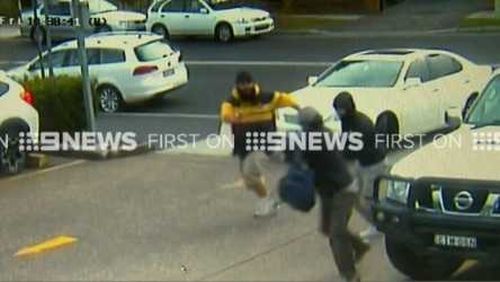 Three masked offenders are on the run after threatening a man outside a Sydney shopping centre. (9NEWS)