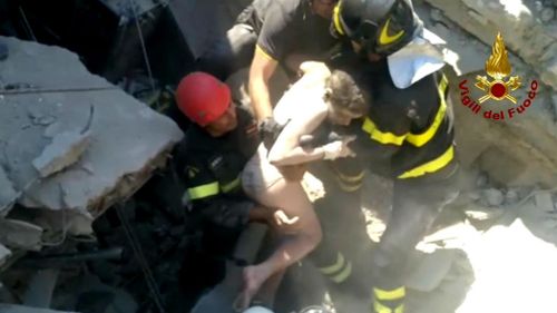 11 year-old Ciro is rescued by Italian firefighters from the rubble of a collapsed building in Casamicciola. (AAP)