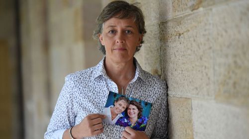 Jill Kindt holds a photo of her with her late wife Jo Grant. (Image: AAP)