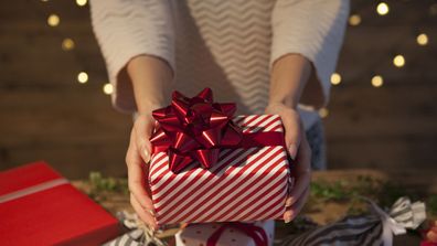 Woman holding wrapped Christmas present 2