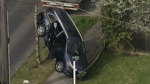 Elderly Melbourne driver causes crash that lands another car against a tree