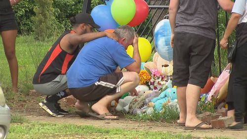 Mr Shorey is comforted at the crash scene where his two sons were killed.