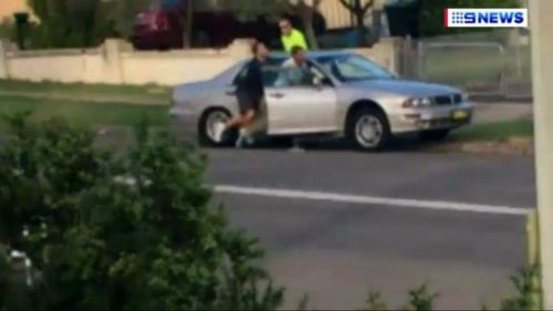 Jared Rose is seen jumping into the car and starting to drive as police are talking to his friend.