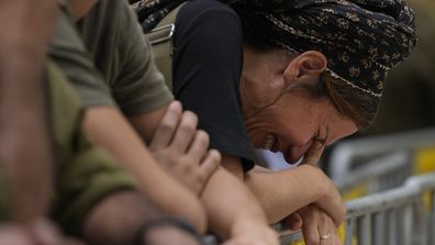 A woman cries during the funeral of Israeli Col. Roi Levy at the Mount Herzl cemetery in Jerusalem on Monday, Oct. 9, 2023. Col. Levy was killed after Hamas militants stormed from the blockaded Gaza Strip into nearby Israeli towns. 