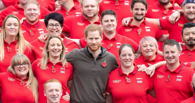 Prince Harry poses with Invictus volunteers during an event in June.