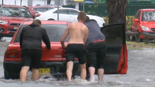 Drivers in Penrith had to push a car out of floodwaters after the violent system hit.