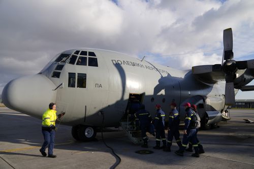 Greek firefighters board a military plane at Elefsina Air Force Base, in western Athens, Greece, Monday, Feb. 6, 2023. 