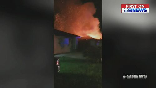 Flames and smoke billow from the burning home. (9NEWS)