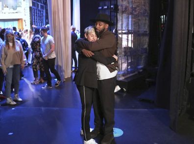 Talk show host Ellen DeGeneres embraces Stephen "tWitch" Boss during a taping of "The Ellen DeGeneres Show" at the Warner Bros. lot in Burbank, Calif. 