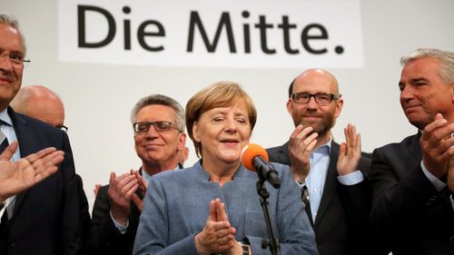 erman Chancellor Angela Merkel (C) of the Christian Democratic Union (CDU) speaks to her supporters at the CDU election event in Berlin. (AAP)