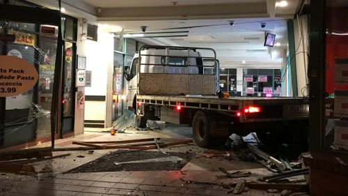 Police are still hunting for two men responsible for ramming two stolen vehicles in a Melbourne shopping centre to steal an ATM.