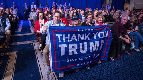 Supporters hold a flag as former President Donald Trump speaks at the Conservative Political Action Conference, CPAC 2023, Saturday, March 4, 2023, at National Harbor in Oxon Hill, Md. (AP Photo/Alex Brandon)