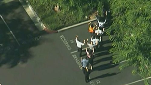 People were seen fleeing the building with their arms raised. (ABC NEWS)