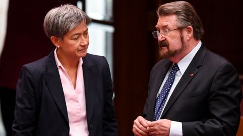 The leader of the Opposition in the Senate Senator Penny Wong, left, speaks to Senator Derryn Hinch after the passing of the Medivac bill.