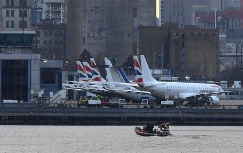 Bomb disposal experts ride a boat near London City Airport in London, Britain, 12 February 2018. An unexploded World War Two bomb was discovered in the Thames nearby causing the airport to be closed. EPA/NEIL HALL