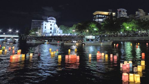 People attend the Peace Message Lantern Floating Ceremony held to console the souls of the A-Bomb victims after the Hiroshima Peace Memorial Ceremony at the Hiroshima Peace Memorial Park on the occasion of the 72nd anniversary of Hiroshima atomic bombing.