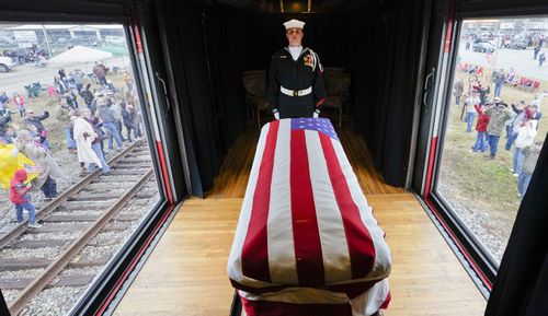 The flag-draped casket of George HW Bush passes through Texas on the special train, named 4141 after the 41st president.