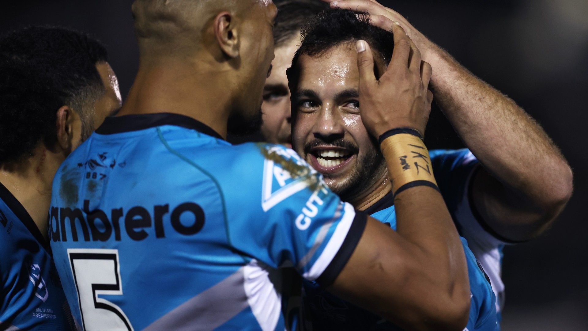 Braydon Trindall of the Sharks celebrates with team mates after scoring a try during the round 21 NRL match between the Cronulla Sharks and the St George Illawarra Dragons at PointsBet Stadium
