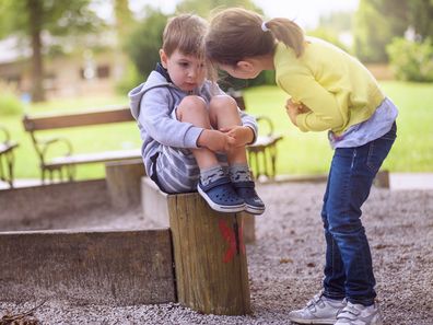 Girl Supporting Sad Boy Sitting Alone on Playground