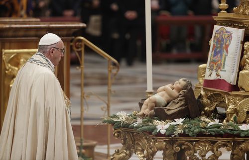 Pope Francis kisses a statue of the Divine Infant as he celebrates a new year's eve vespers Mass in St. Peter's Basilica at the Vatican, Sunday, Dec. 31, 2017.  (AAP)