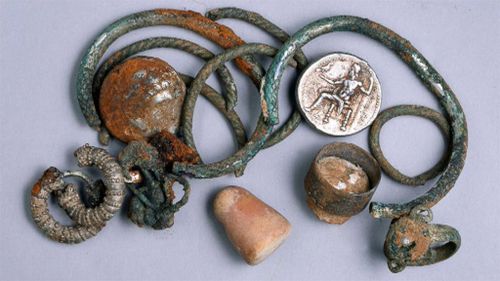 Among the artefacts recovered are two coins from the era of Alexander the Great, three rings, four bracelets and five earrings. (Clara Amit/The Israel Antiquities Authority)