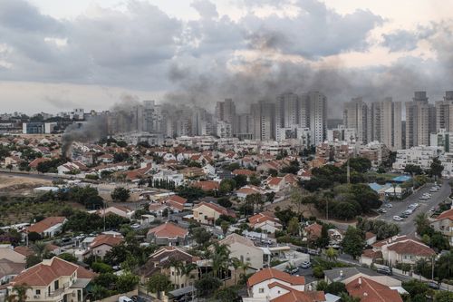 Smoke rises after a rocket fired from the Gaza Strip hit a house in Ashkelon, southern Israel, Saturday, Oct. 7, 2023.  