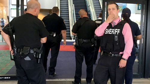 Police officers gather at a terminal at Bishop International Airport in Flint, Michigan. (AAP)