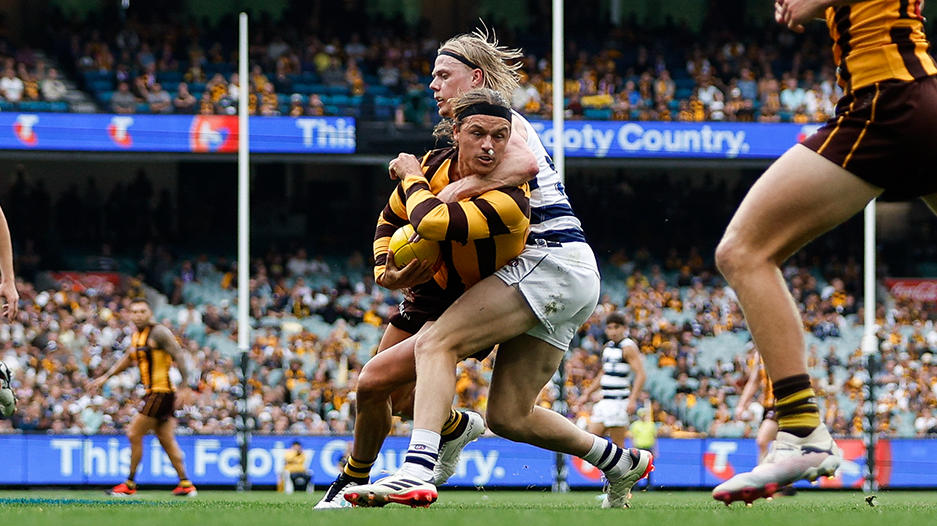 Jack Ginnivan of the Hawks is tackled high by Zach Guthrie of the Cats during their round three clash.