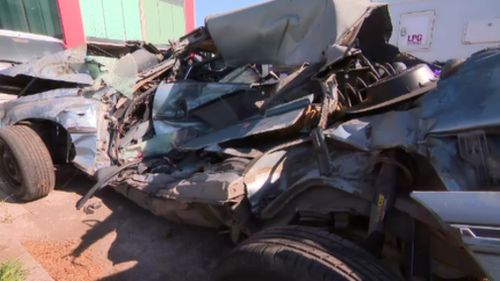 The owner of the crumpled Holden wants it to remain on the road as a reminder for drivers to "slow down". (9NEWS)