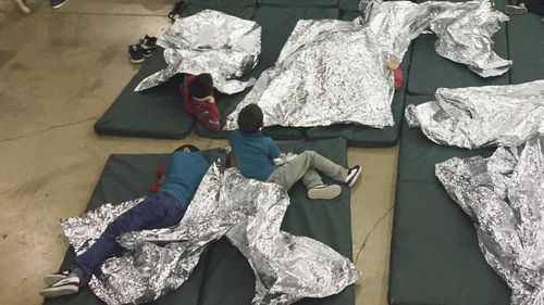Children sleep on the concrete floor of a immigration detention facility.