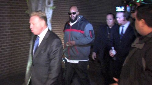 Death Row Records founder Marion 'Suge' Knight, right, walking into the Los Angeles County Sheriff's department. (AAP)
