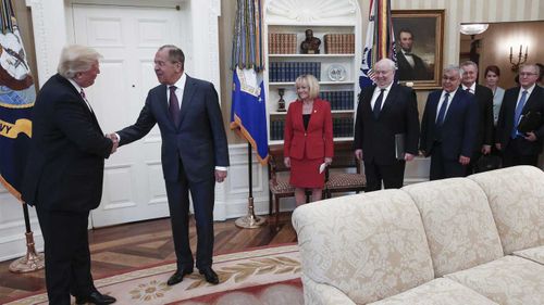 Donald Trump meeting with Sergey Lavrov, with a woman falsely purported to be Mariia Butina in the background. (TASS)