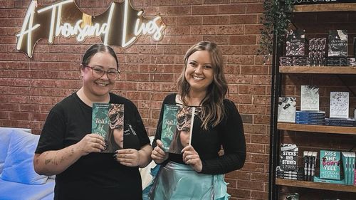 Caitlyn (left) with an author at one of A Thousand Lives Book Haven's reader events.