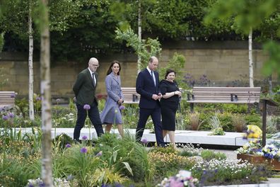 The memorial designer Andy Thomson, left, the director of BCA Landscape and Joanne Roney, right, the chief executive of Manchester City Council show Prince William and his wife Kate around as they attend the launch of the Glade of Light Memorial garden, outside Manchester Cathedral, which commemorates the victims of a suicide bomb attack at a 2017 Ariana Grande concert, in Manchester, England, Tuesday, May 10, 2022.