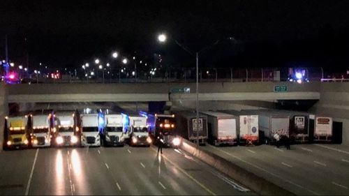 Michigan Police teamed up with 13 semi-trailer truckers to prevent a man from taking his own life on Detroit's I-696 highway. Picture: Fox2 News.