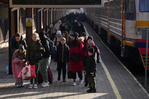 People fleeing the conflict from neighboring Ukraine arrive to Przemysl train station in Przemysl, Poland, Saturday, Feb. 26, 2022. (AP Photo/Petr David Josek)