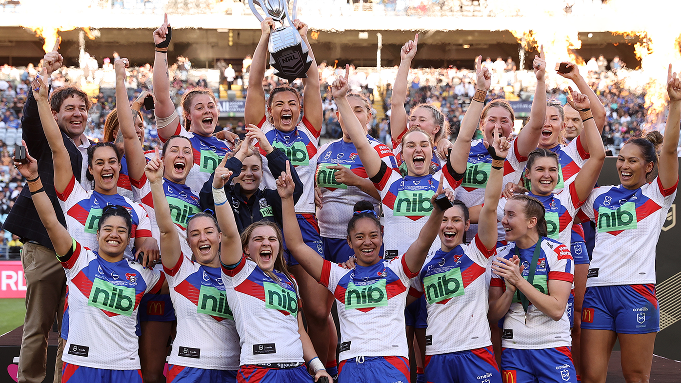 The Knights celebrate with the NRLW premiership trophy after victory in the 2022 NRLW grand final.