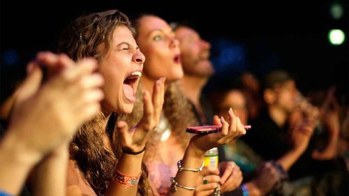 Fans react to The Wailers performing live on stage at the 2016 Byron Bay Bluesfest.