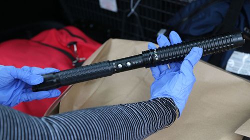 A number of weapons including a baton taser were seized. (NSW Police)