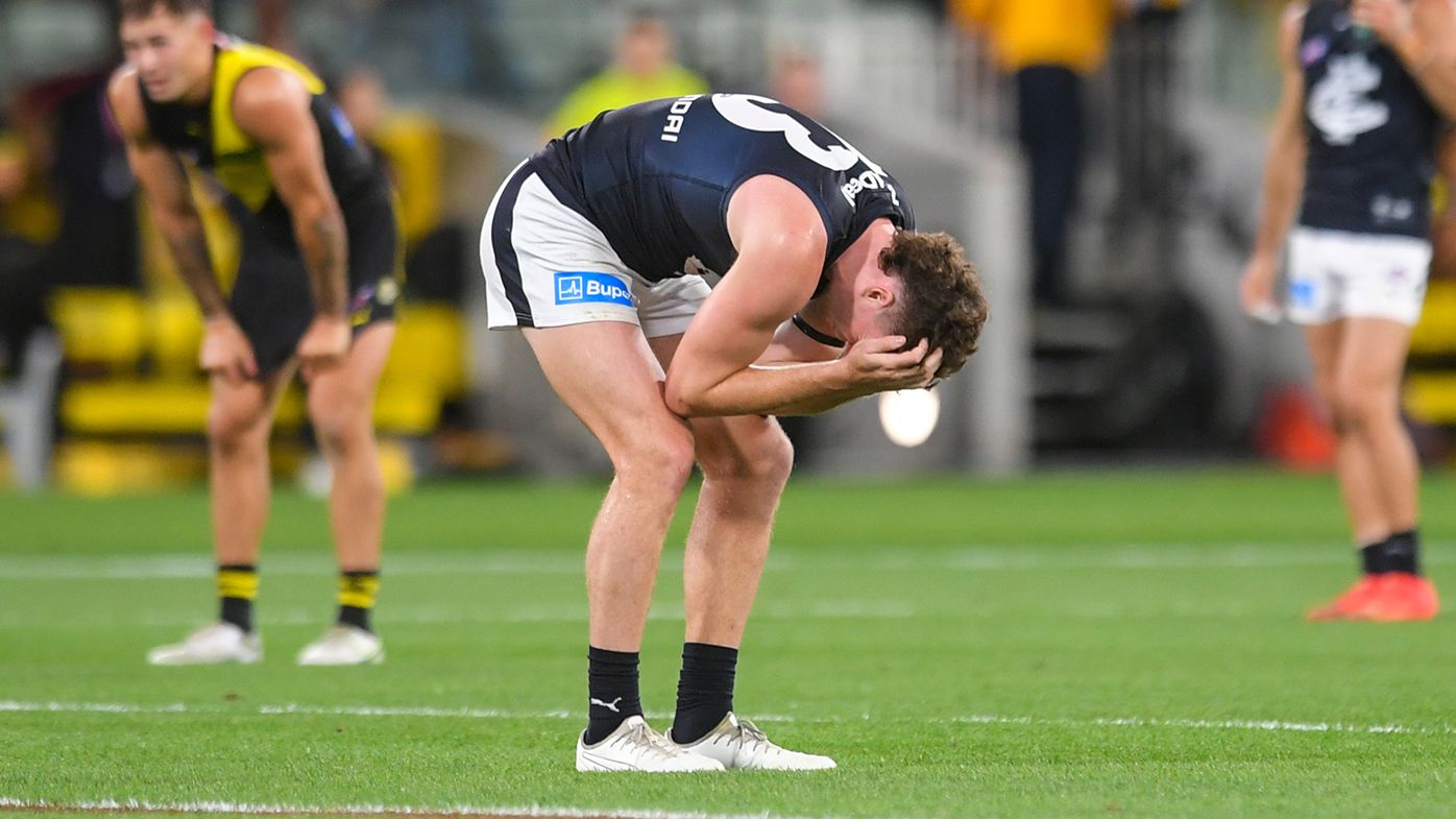 Blake Acres (Carl) is distraught after dropping a mark in the final moments that could have won Carlton the game.