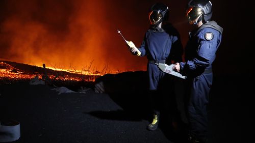 Military Emergency Unit personal take gas reading measurements near a volcano on the Canary island. 