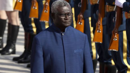 Solomon Islands Prime Minister Manasseh Sogavare reviews an honor guard during a welcome ceremony at the Great Hall of the People in Beijing, on Oct. 9, 2019. 