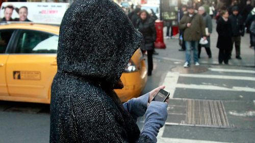 Calls to double fines for pedestrians who cross roads while using mobile phones