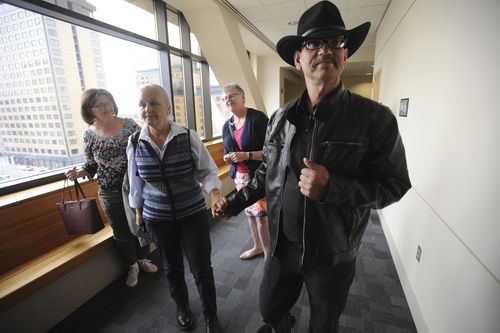 Timothy Hoffman, right, father of slain teenager Cynthia Hoffman receives support from Edie Grunwald, left, who's son David Grunwald was murdered in November.  (Bill Roth/Anchorage Daily News via AP)